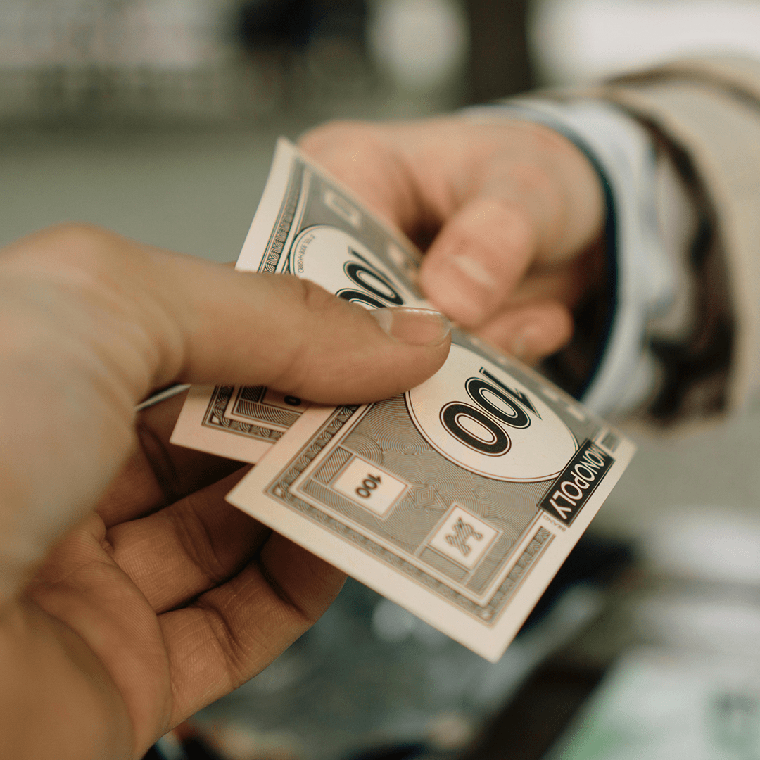 A person giving cash to another individual in a transaction.